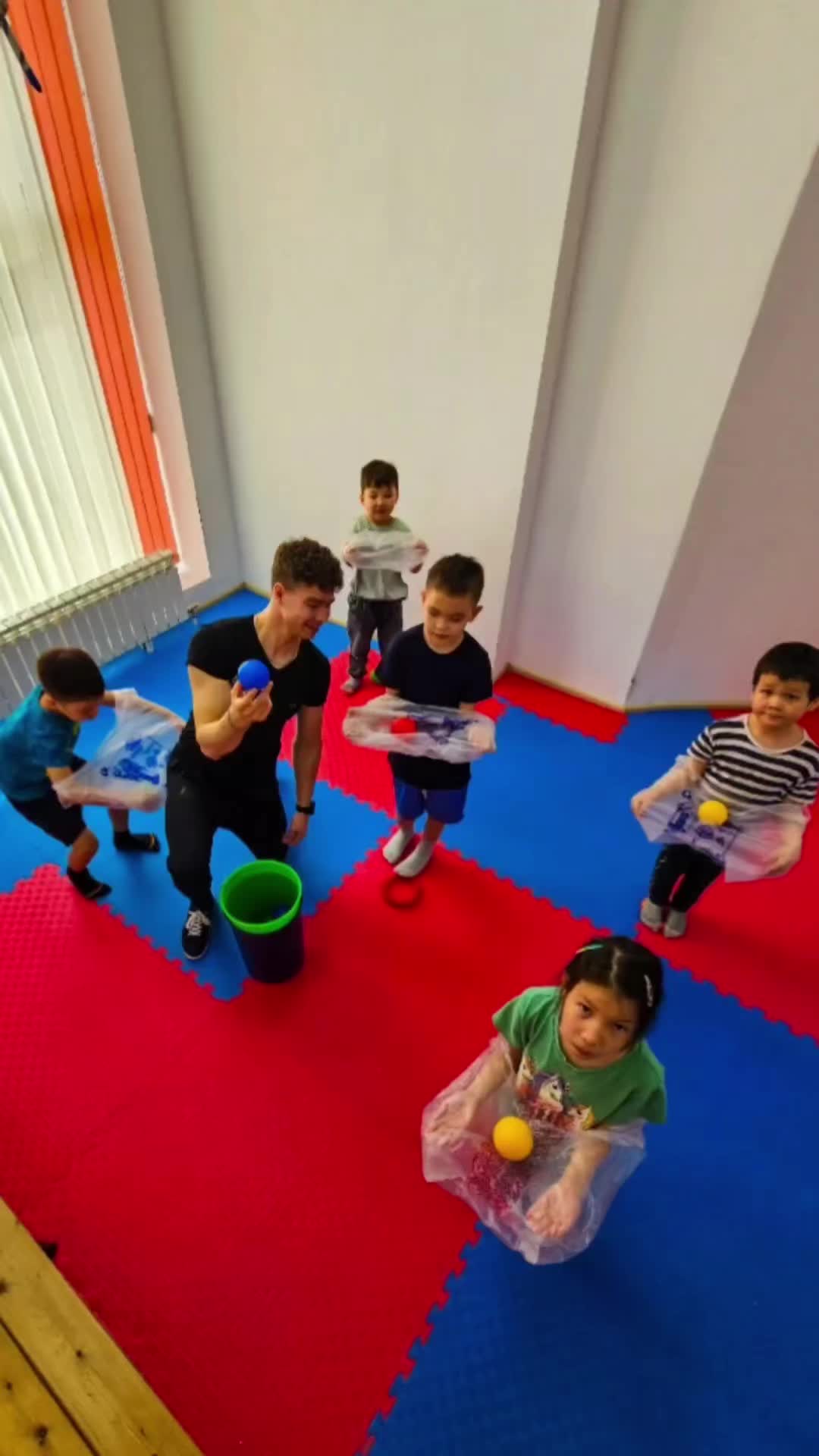 This may contain: a group of children playing with toys in a room