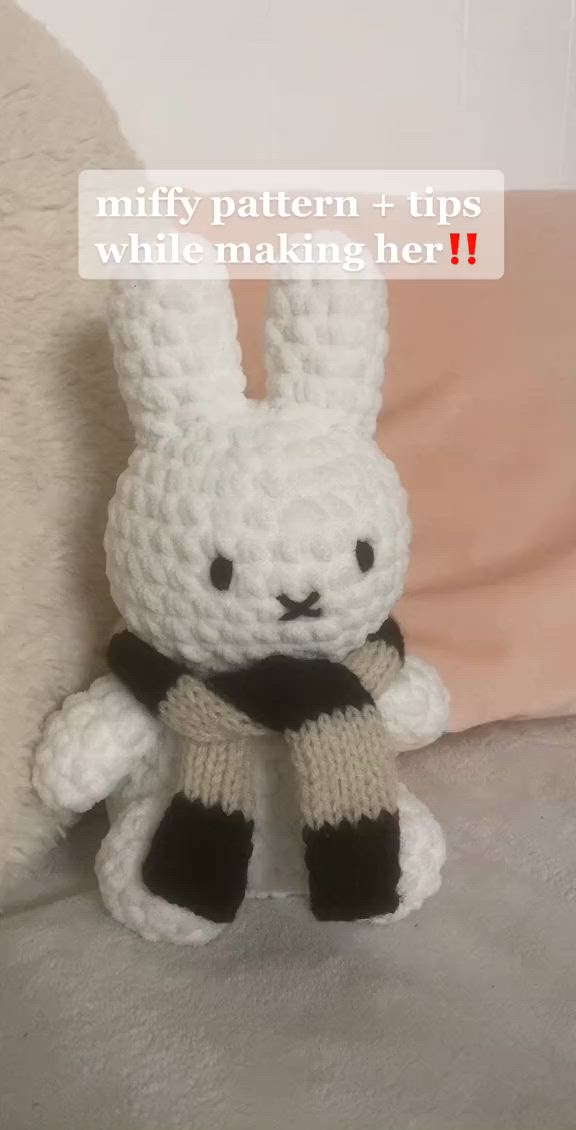 This may contain: a white crocheted stuffed animal with black legs