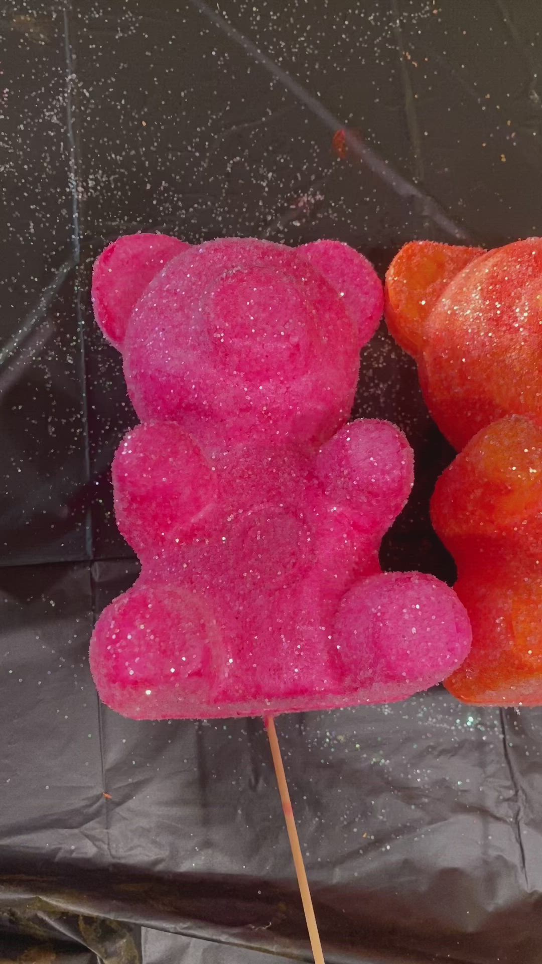 This may contain: two gummy bears sitting on top of each other