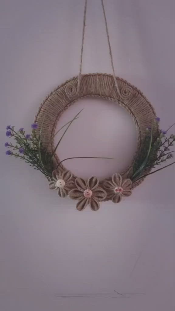 This may contain: a wicker wreath with flowers hanging from it