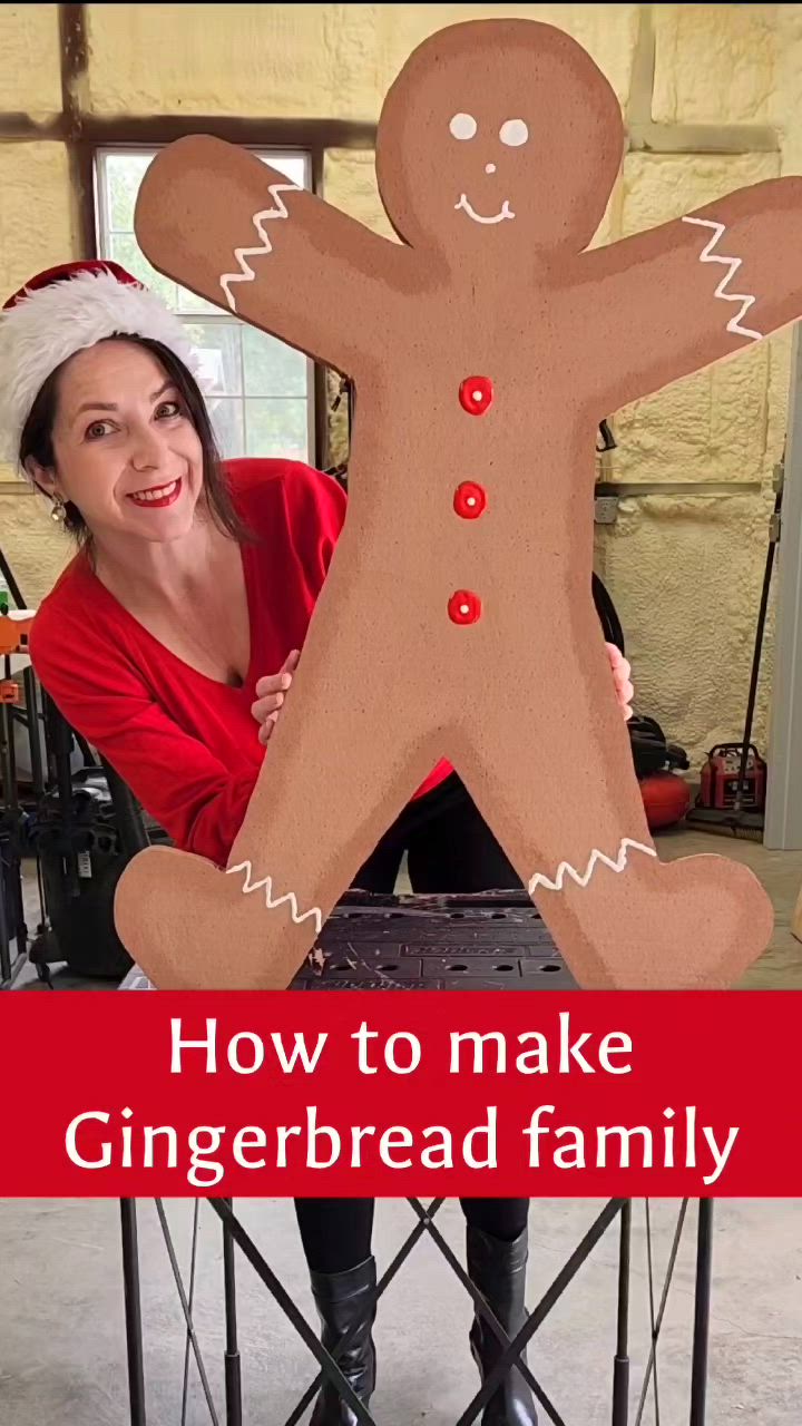 This may contain: a woman holding up a cardboard cut out of a gingerbread man with the words how to make a gingerbread family