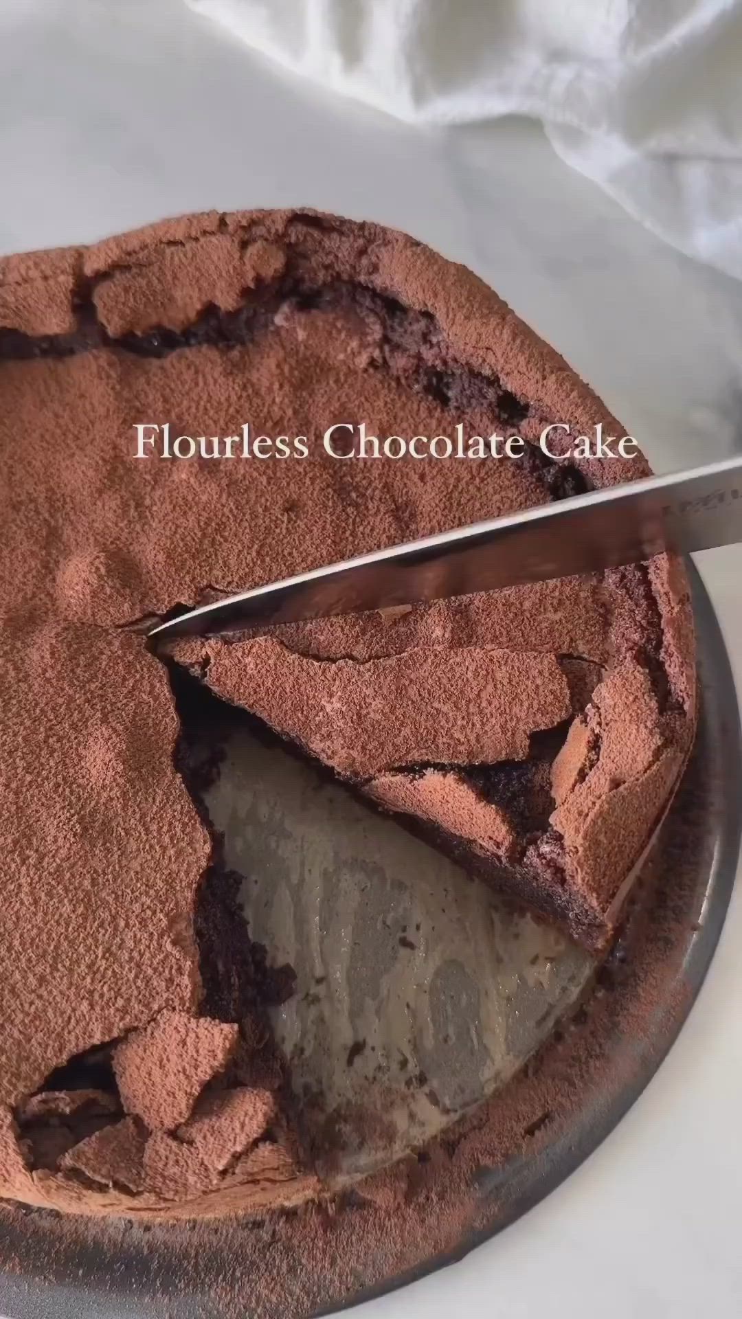 This may contain: a piece of chocolate cake with whipped cream and raspberries on a plate next to a fork