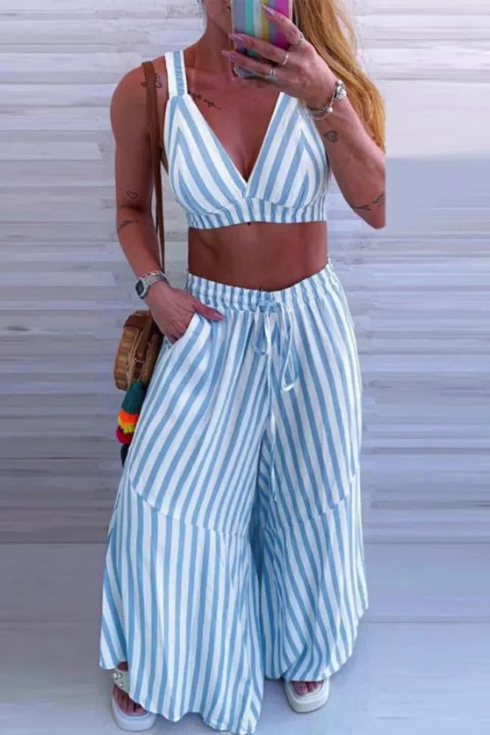 "Turn heads in this Sexy Stripe Ruffle V Neck Sleeveless Two-Piece set. Perfect for day-to-night transitions, its playful ruffles and flattering silhouette ensure you stand out with style."