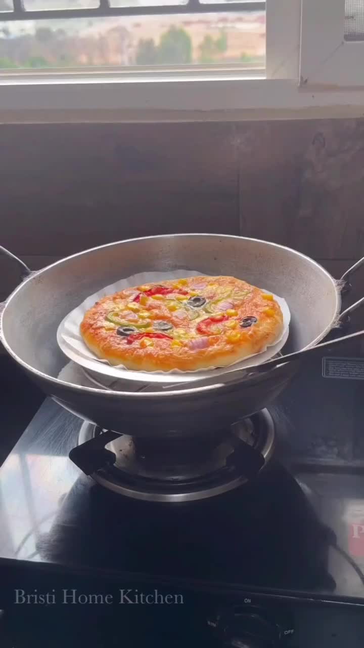 This may contain: a pizza sitting in a pan on top of a stove