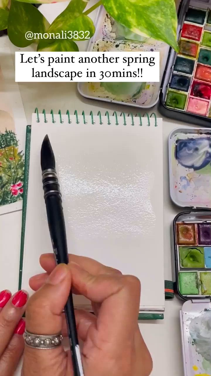 This may contain: someone is doing something on their desk with some paint and watercolors in front of them