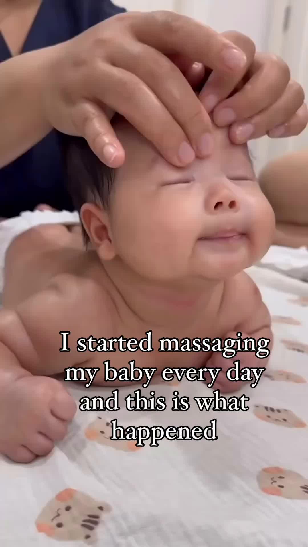 This may contain: a baby being held up to its face with the caption, i started massageing my baby every day and this is what happened