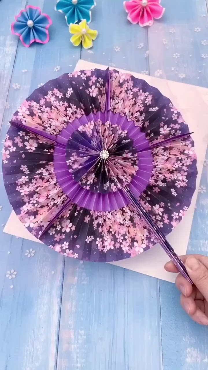 This contains an image of: How to Make Stunning Paper Fans