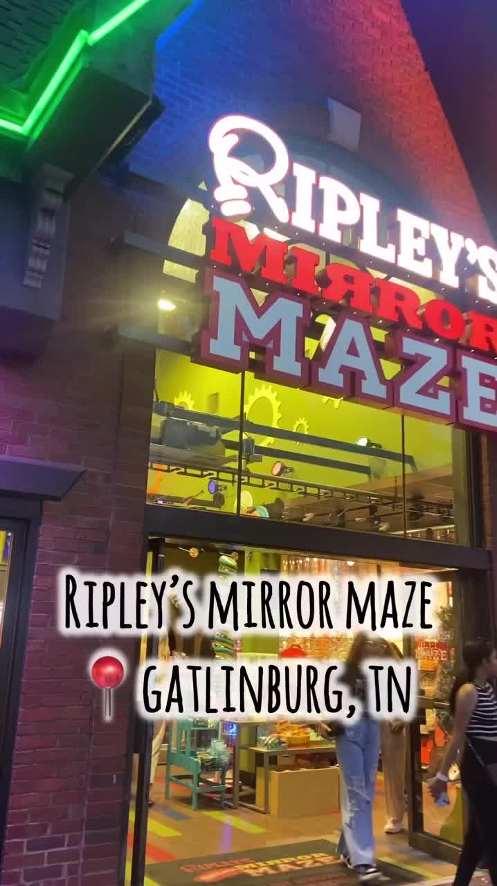 This may contain: people walking in front of a store with the words ripley's mirror maze on it