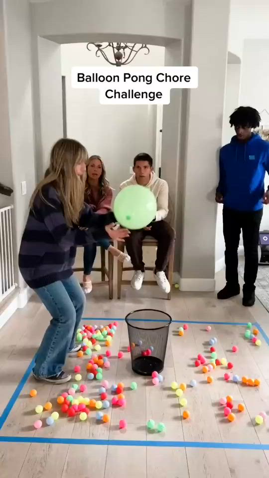 This may contain: a group of people in a room playing with balls