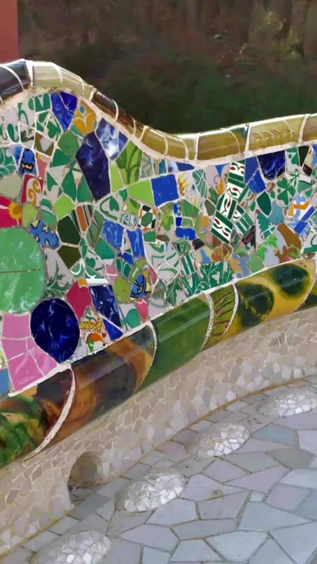 This may contain: a bench made out of different colored tiles