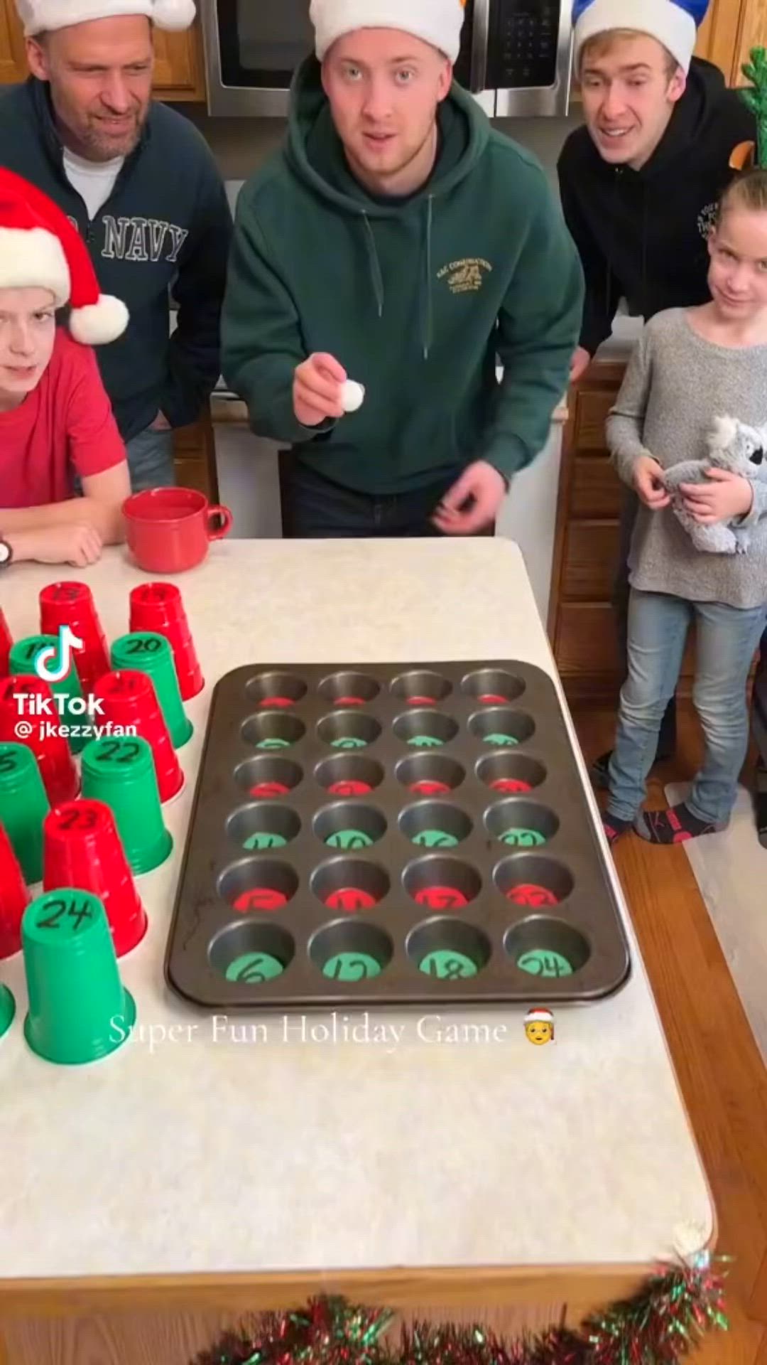 This may contain: a group of people standing around a table with cupcakes in front of them