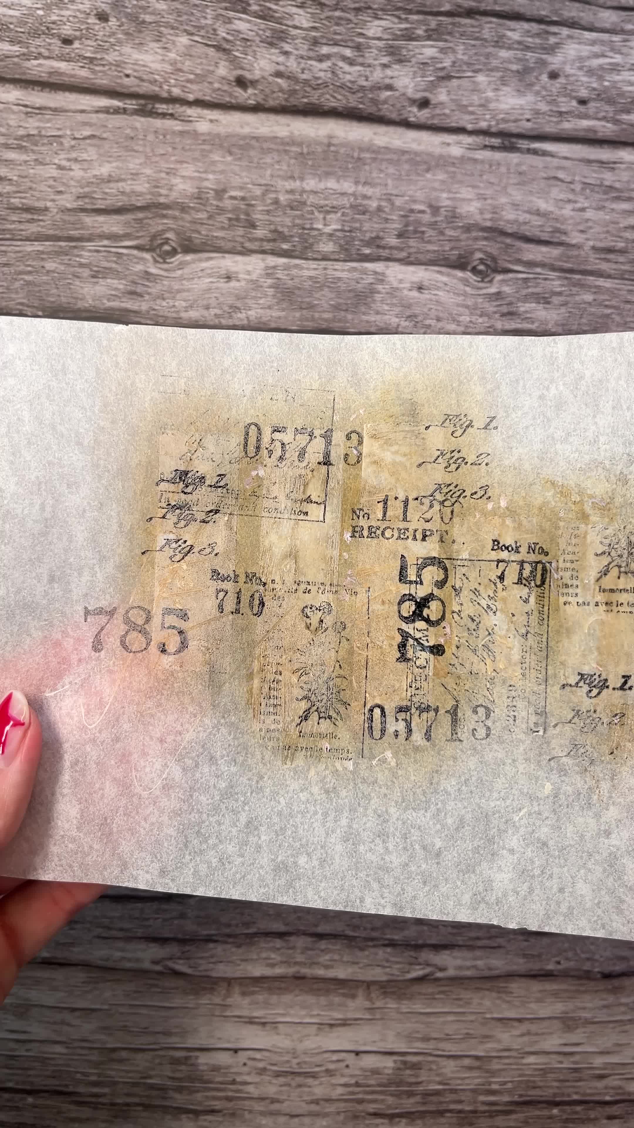 This may contain: a person's hand holding onto a piece of paper with stamps and numbers on it