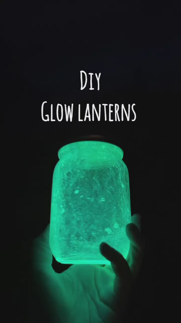 This may contain: a hand holding a glowing glower in the dark with text overlay that reads diy glow lanterns