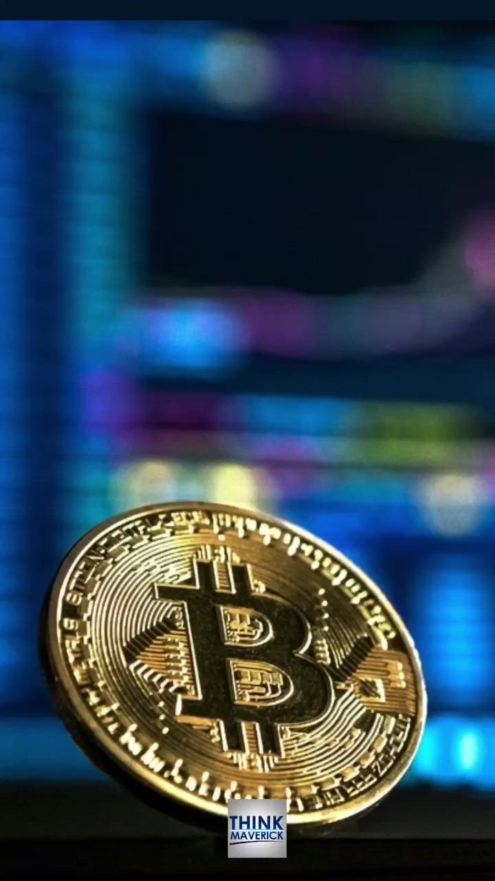 This may contain: a bitcoin sitting on top of a table in front of a computer screen