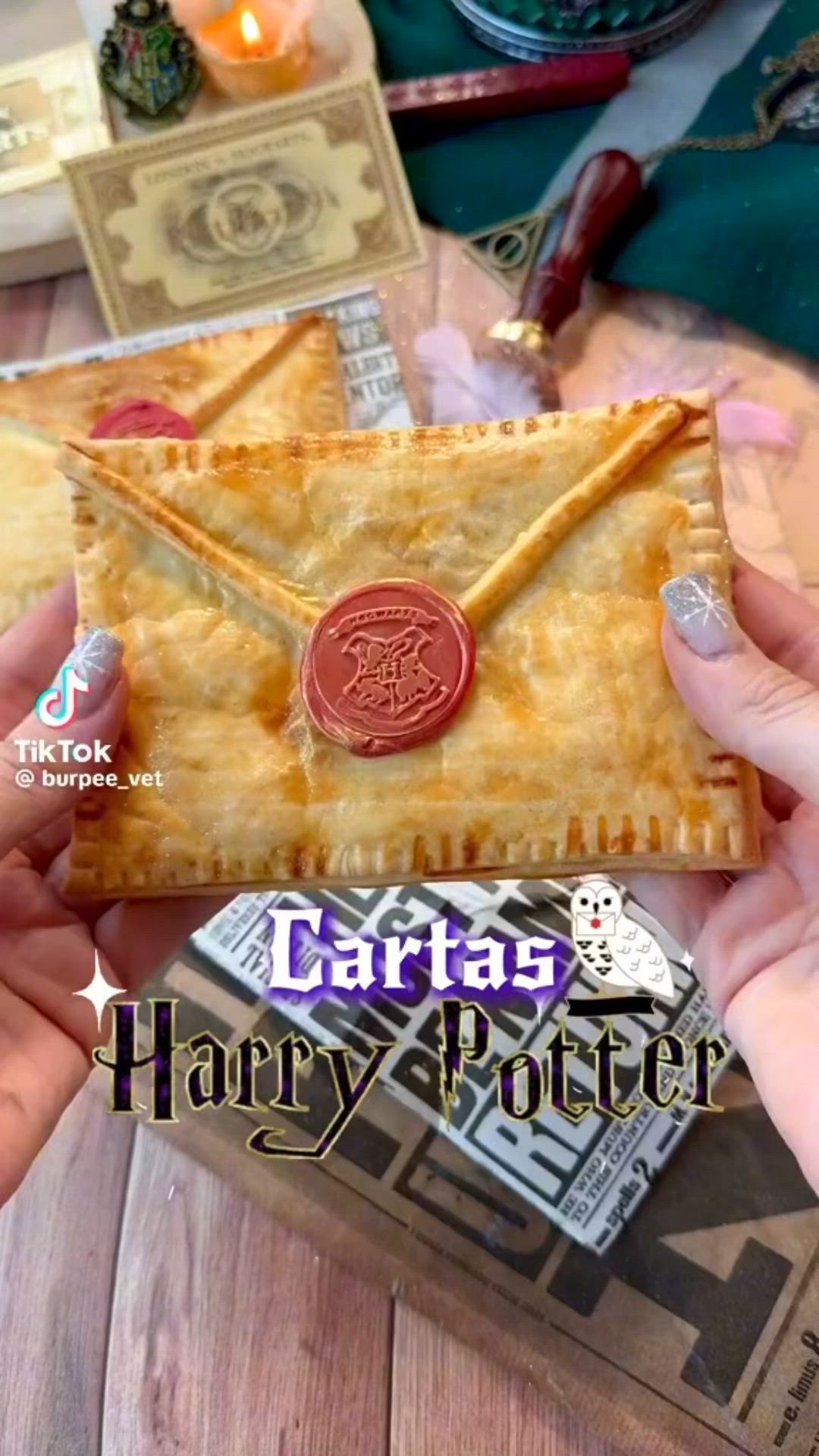 This may contain: two hands holding a harry potter quiche with a wax stamp on it and the caption says carttass harry potter