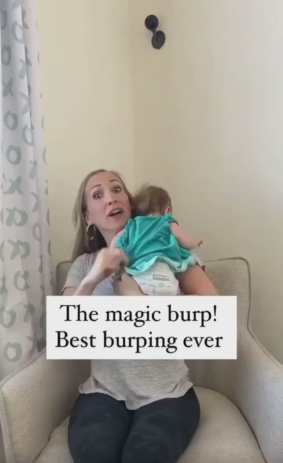 This may contain: a woman holding a baby in her arms with the caption'the magic burp best burning ever '