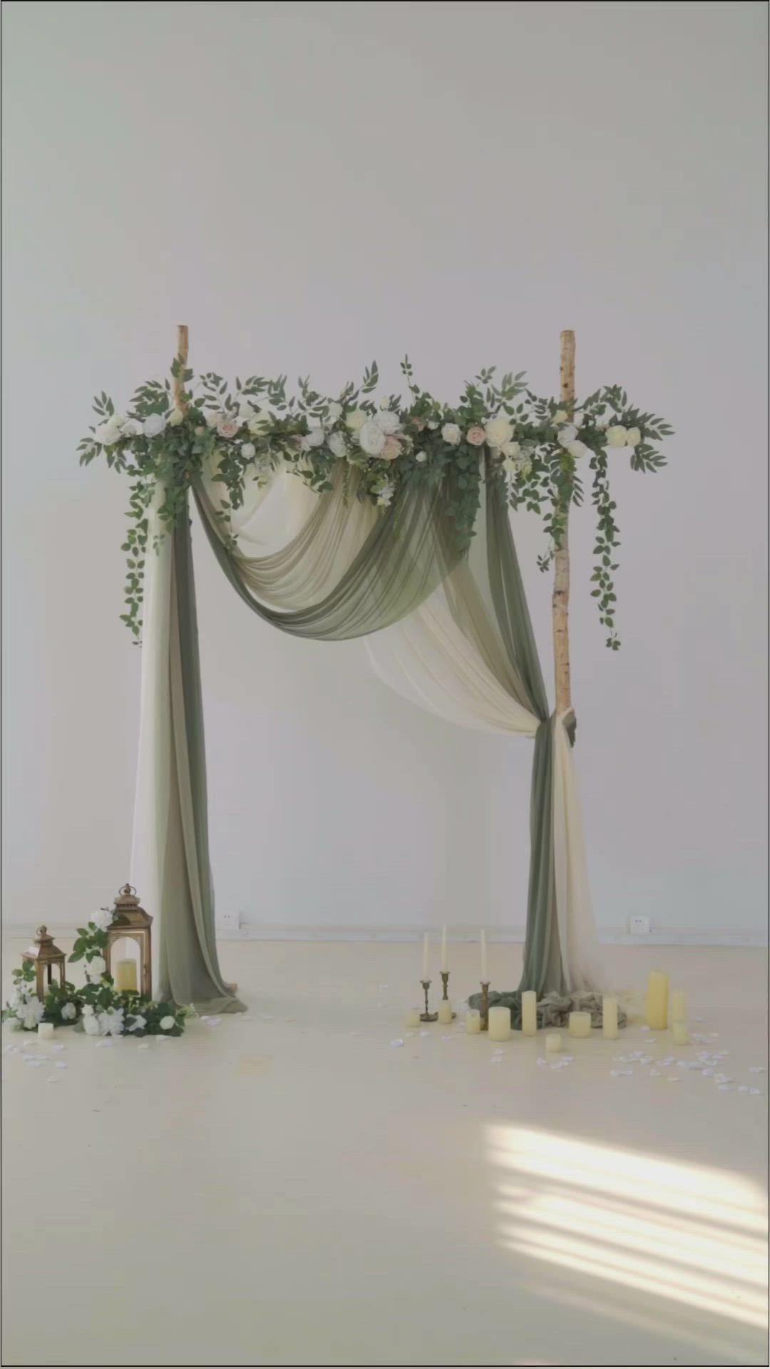 This may contain: a wedding arch decorated with greenery and candles