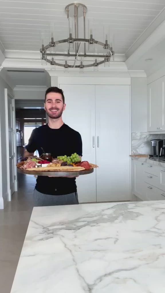 This may contain: a wooden platter filled with different types of food