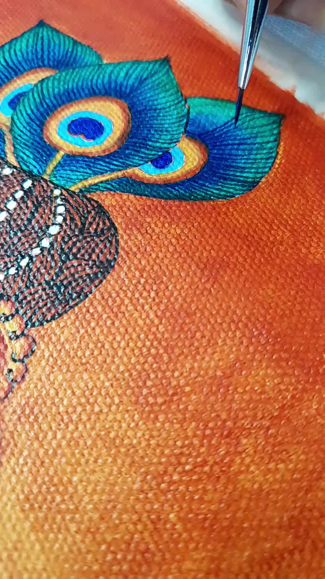 This may contain: a peacock is sitting on an orange surface with a needle in its beak and it's feathers are blue