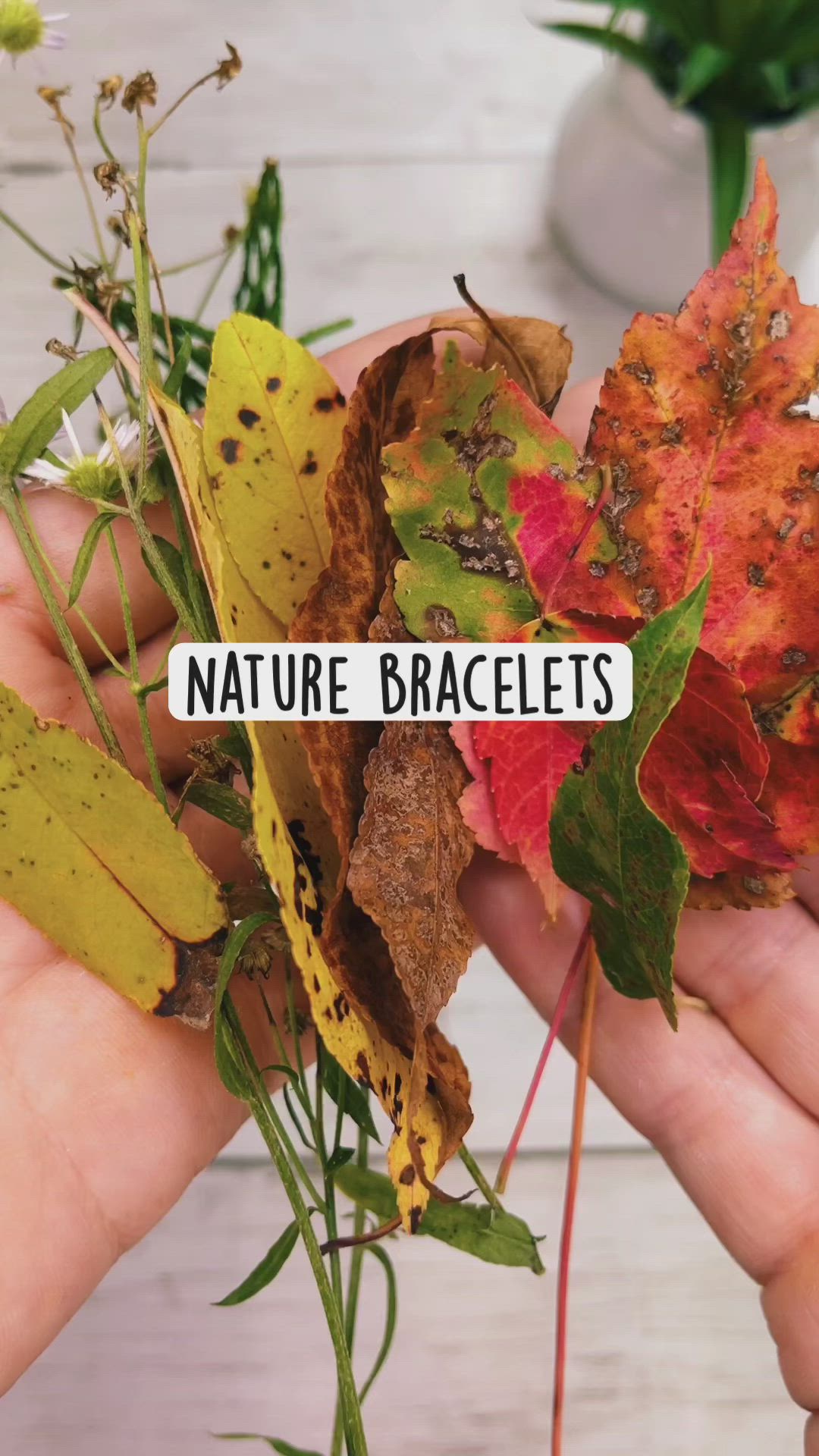 This may contain: someone holding up some leaves with the words nature bracelets on it in front of them