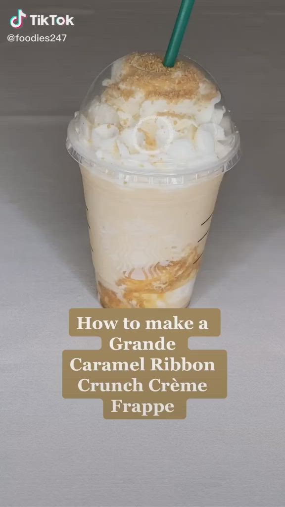 This may contain: a hand holding a drink with the words how to make a caramel ribbon crunch creme frappe