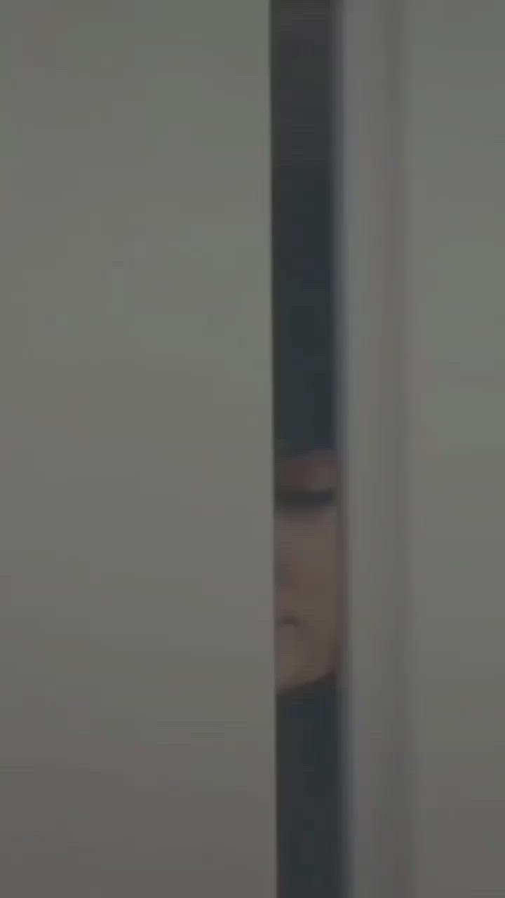 This may contain: a blurry image of a woman's face through a door with her eyes closed