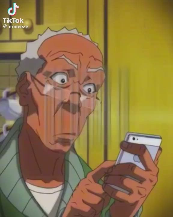 This may contain: an older man looking at his cell phone