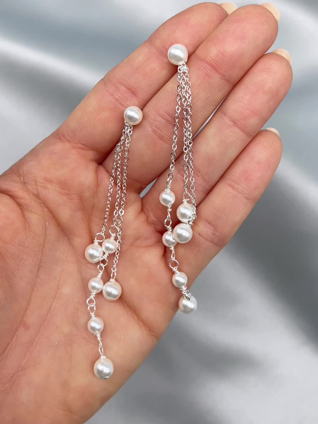 Elegance meets drama in our Kendall Pearl Earrings. These duster earrings are designed with off white pearls dangling from delicate chains of varying lengths. Lightweight for easy day to night wear. Off white, glass pearls Measures 3" in length Hypoallergenic, lead-free & nickel-free Style #4458