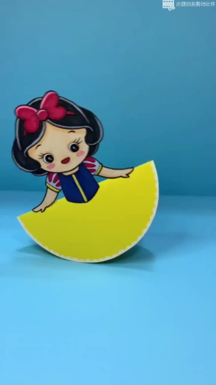 This may contain: a paper doll sitting on top of a yellow moon with a bow in her hair