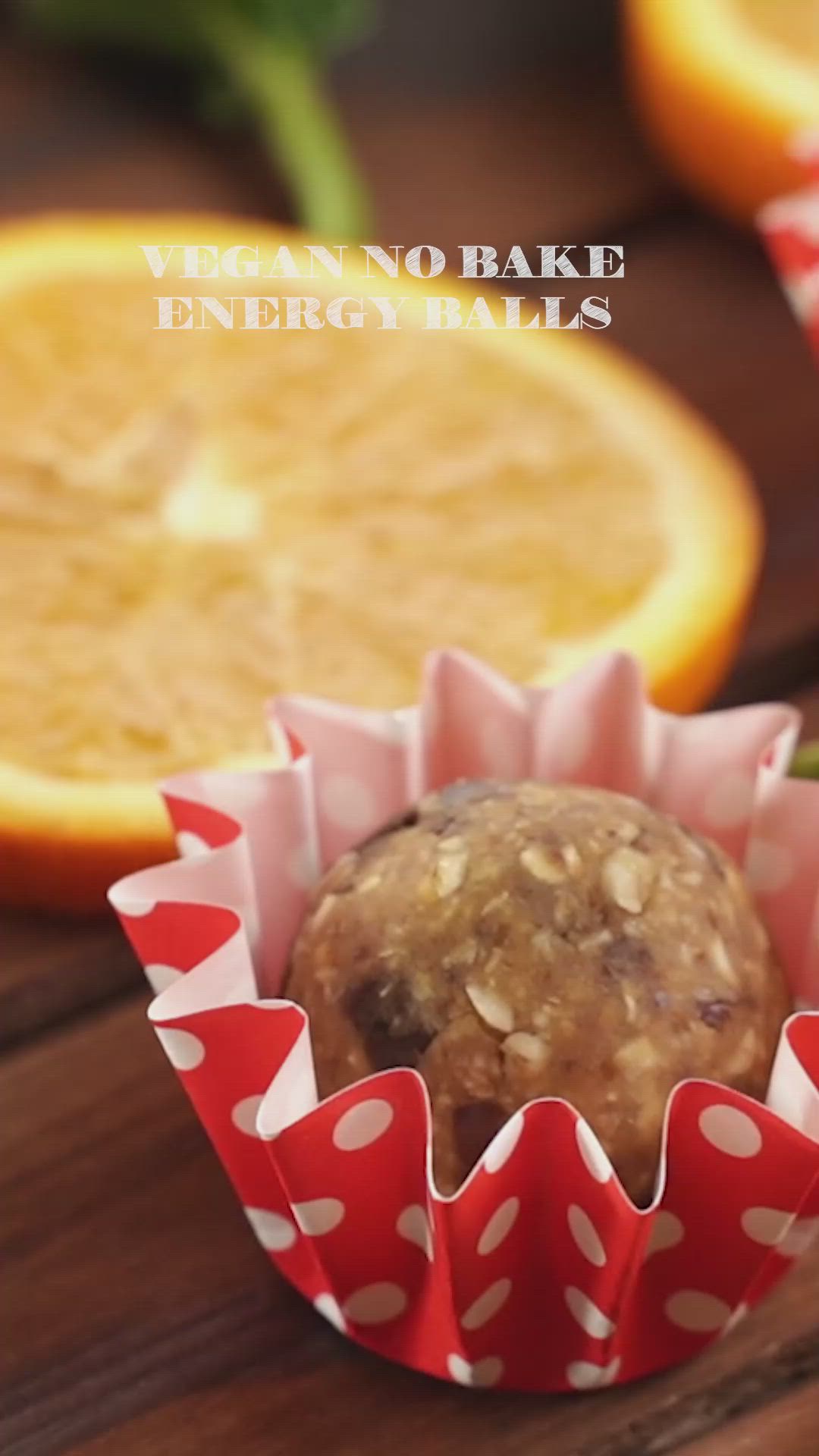 This may contain: a close up of a muffin in a wrapper with oranges behind it