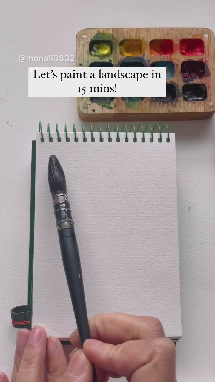 This may contain: an artist's notebook with watercolors and a painting on it