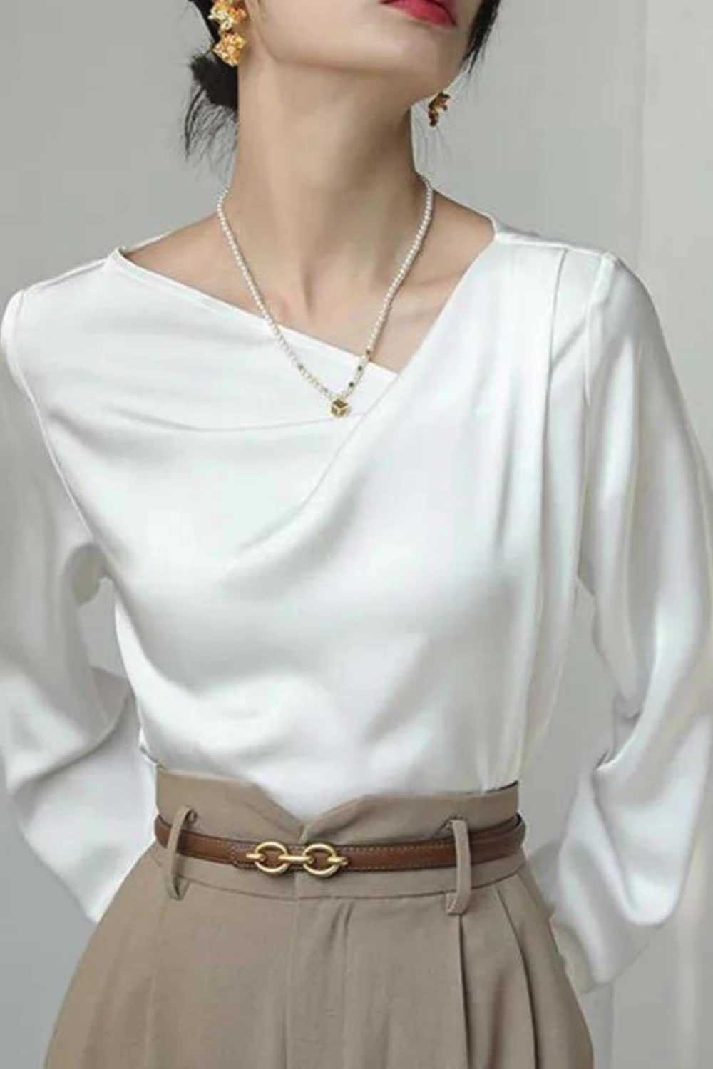 "Upgrade your wardrobe with our Asymmetric Pleated Solid Color Long Sleeves Loose V-Neck Blouses & Shirts. Featuring a unique asymmetric design, elegant pleats, and a flattering V-neckline, this blouse combines style and comfort for any occasion."