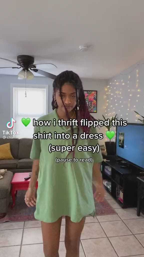 This may contain: a woman standing in front of a tv with the caption how i thrift flipped this shirt into a dress super easy