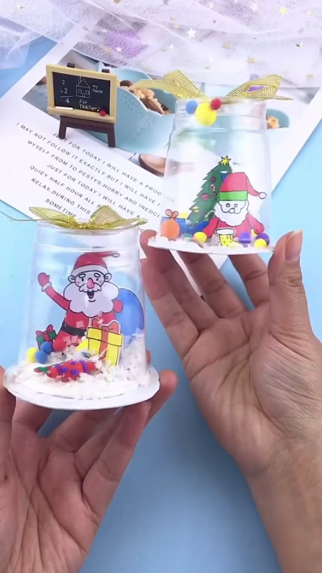 This may contain: two hands holding small plastic cups with cartoon images on them