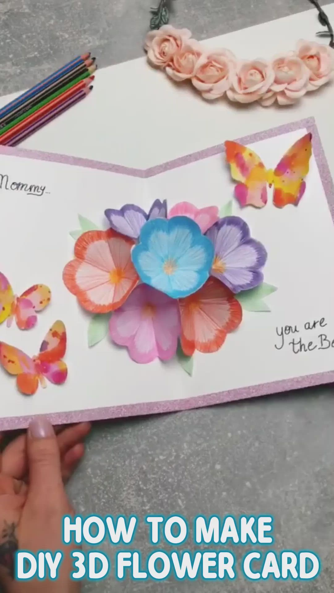 This may contain: someone is making a card with flowers and butterflies