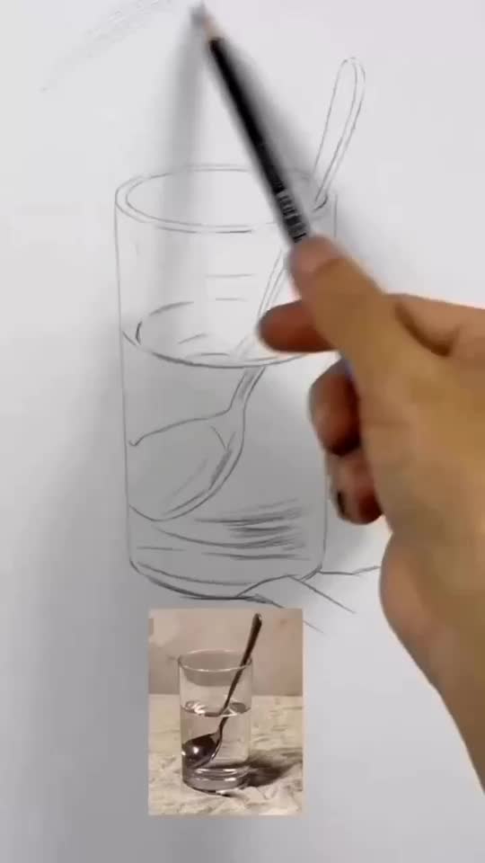 This may contain: a person is drawing on paper with a pen and inking the image in front of them