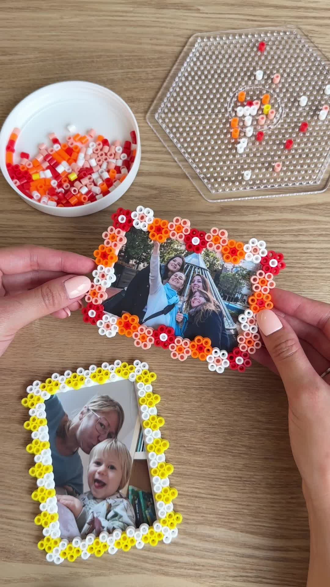 This may contain: two hands holding up a photo frame made out of beaded beads with the words, diy fusse beads frame