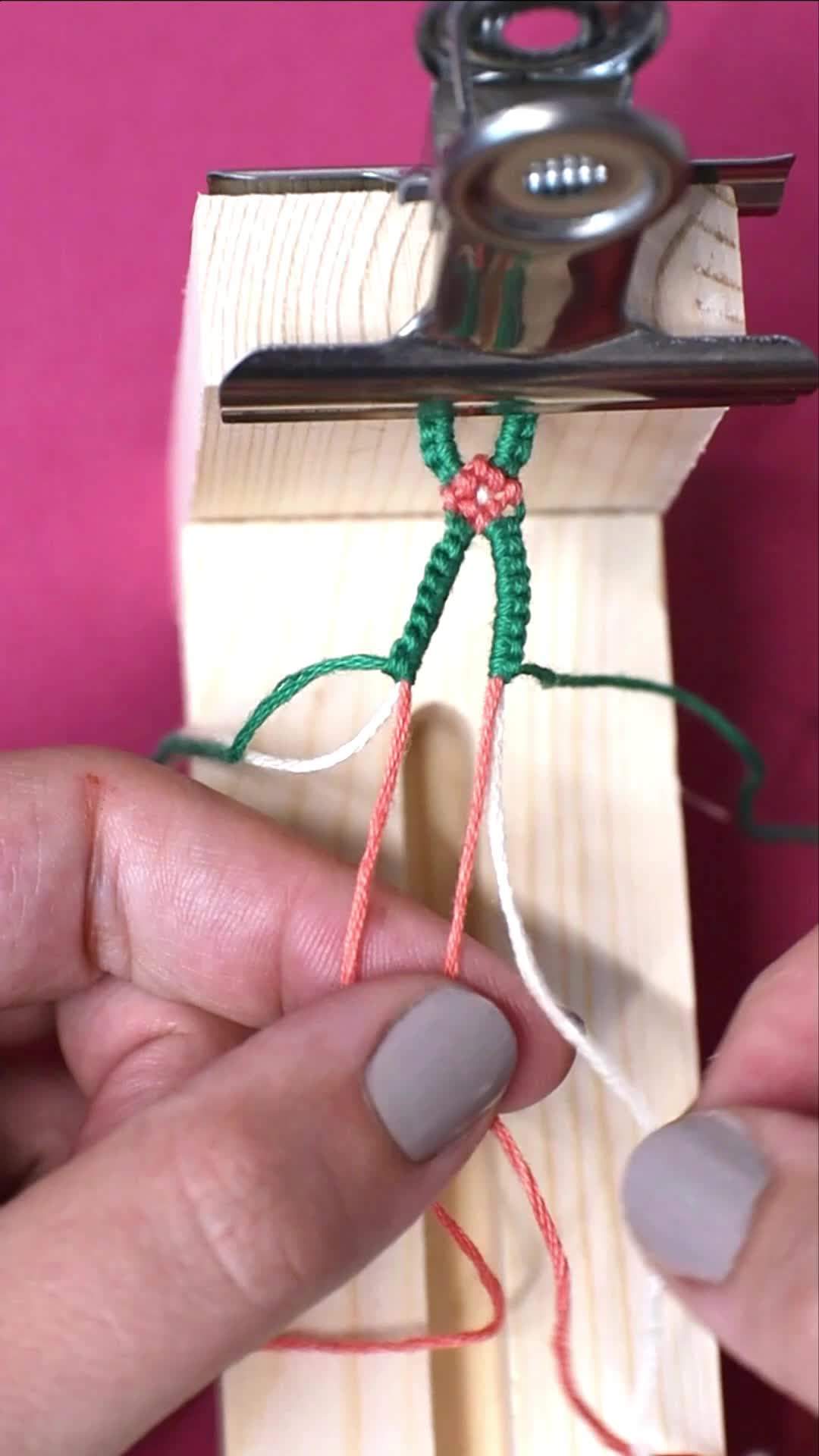 This may contain: someone is working with some string on the end of a piece of wood and scissors