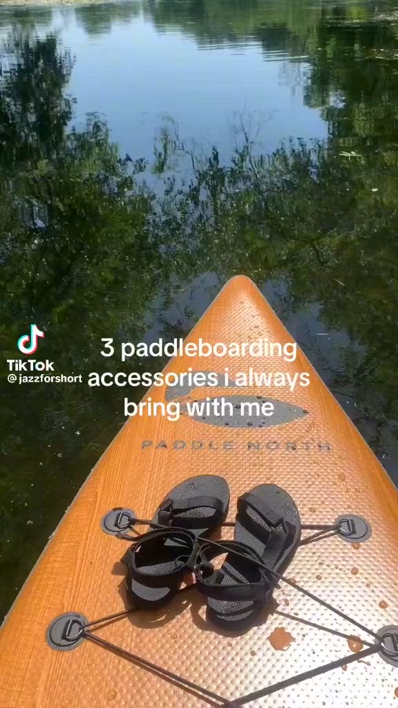 This may contain: a kayak with two pairs of sandals on the front