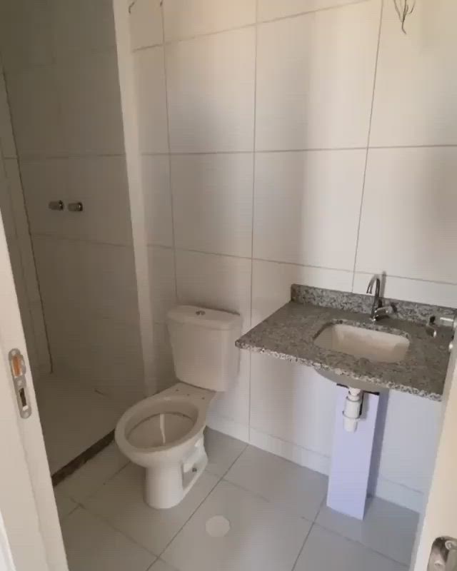 This may contain: a bathroom with a toilet, sink, and shower in it's own area