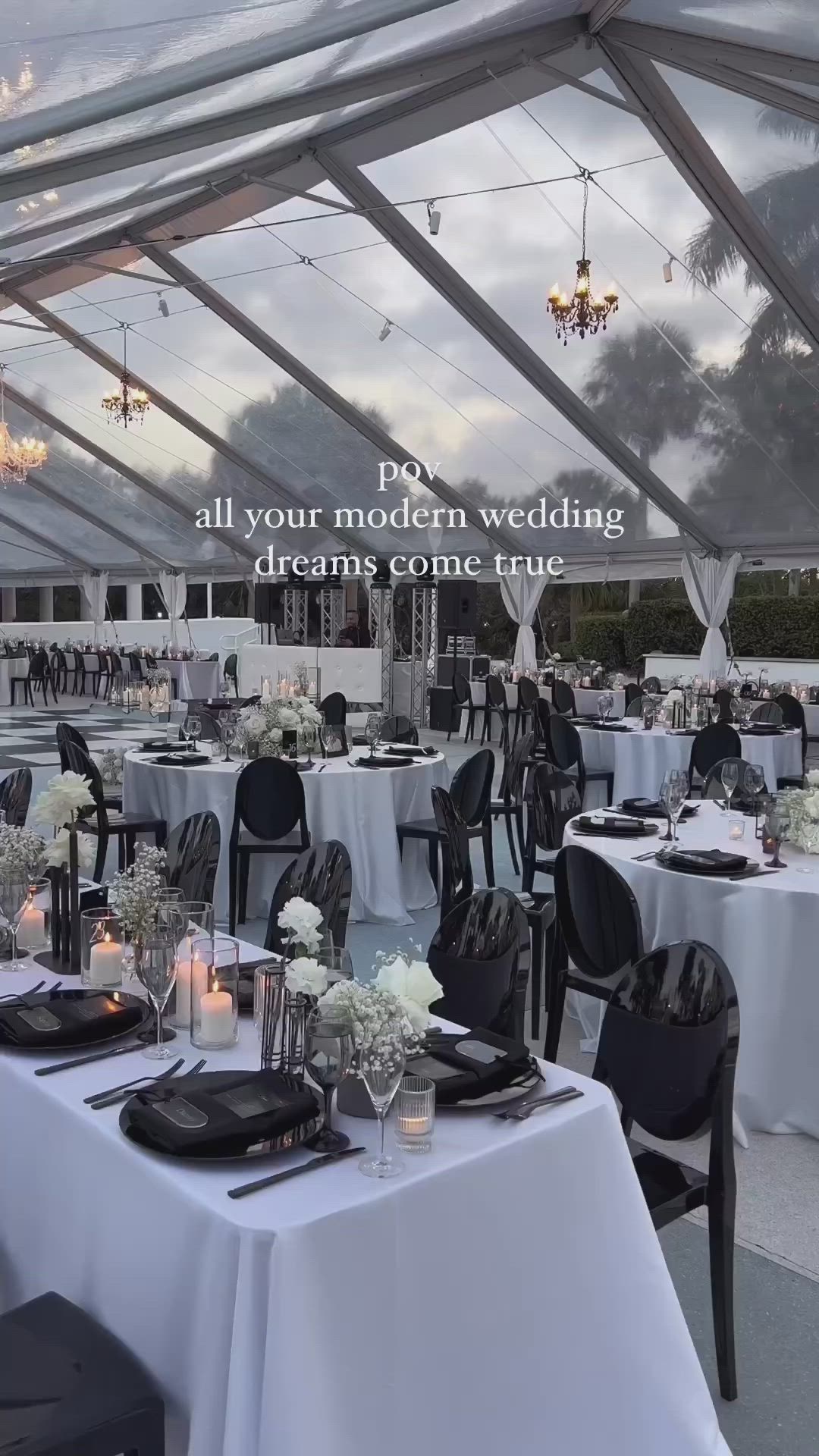 This may contain: an outdoor tent with tables and chairs set up for a wedding reception in the evening