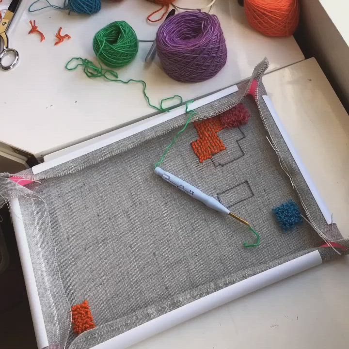 This may contain: yarn and crochet are laid out on a table