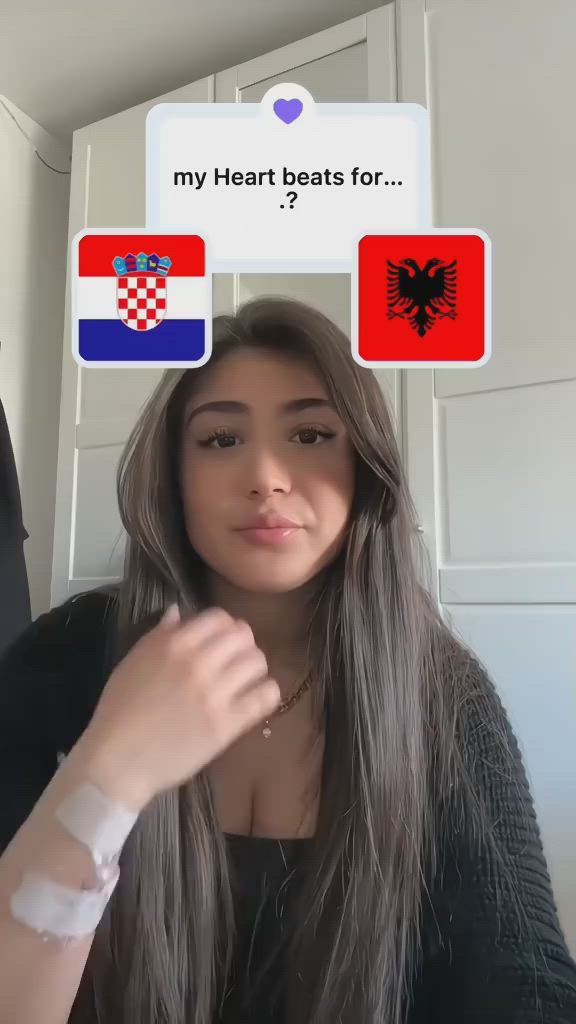 This may contain: a woman with long hair and two stickers on her face that say, my heart beats for croatia