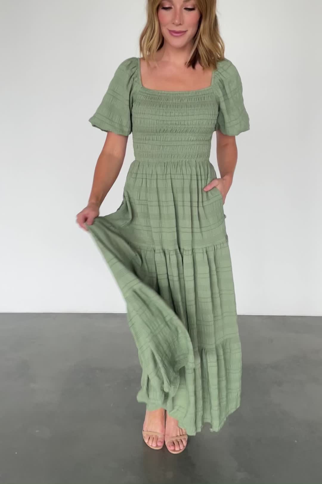 Baltic Born exclusive style Perfect dress for any occasion Textured crepe material with some stretch Soft light Green color Square neckline Balloon style sleeve with elastic at shoulder Fully smocked bodice Maxi length dress with three tiers Fully lined Marianne is 5'6, cup size 34D, size 6 and wearing size S