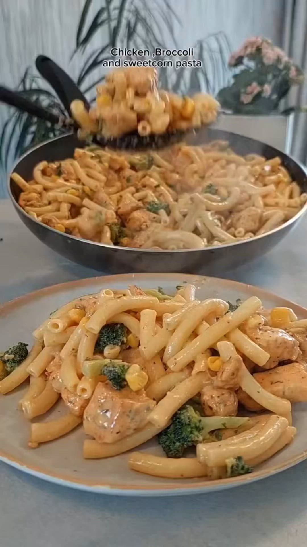 This may contain: two plates of pasta with chicken and broccoli on them, next to a skillet