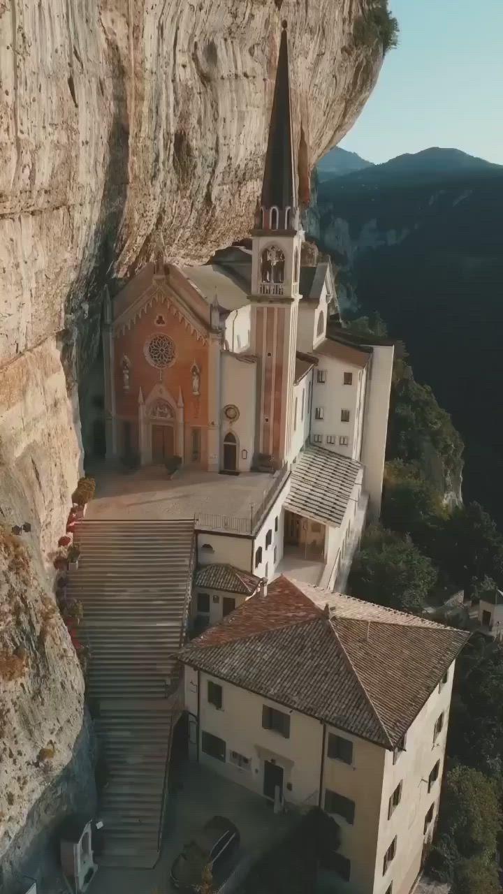 This may contain: an old church built into the side of a cliff