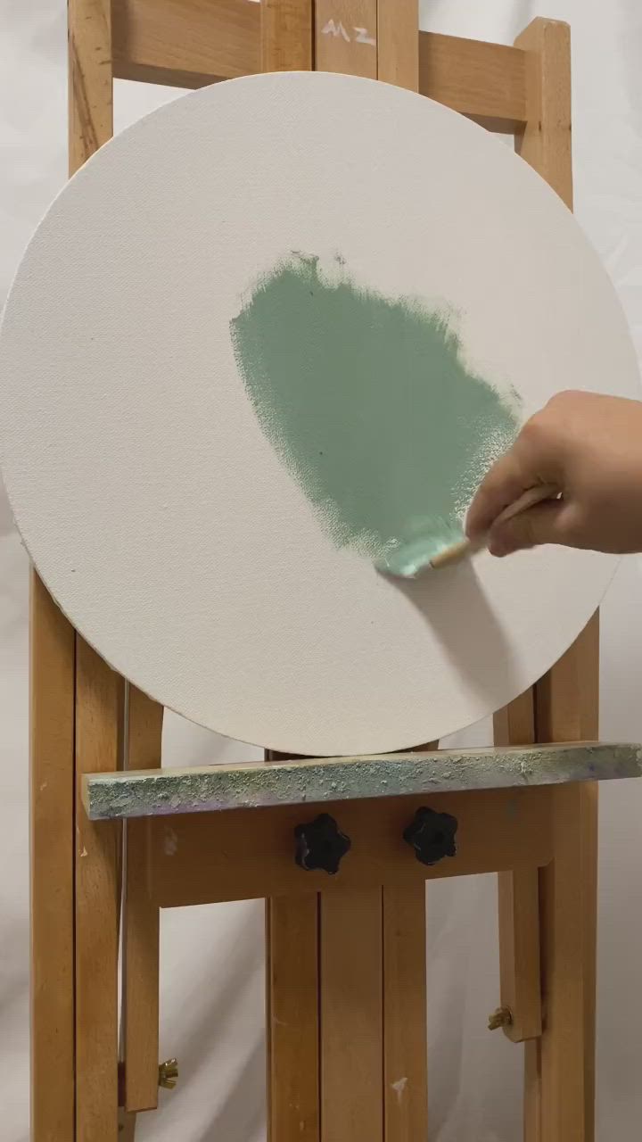 This may contain: a green plate sitting on top of a wooden easel