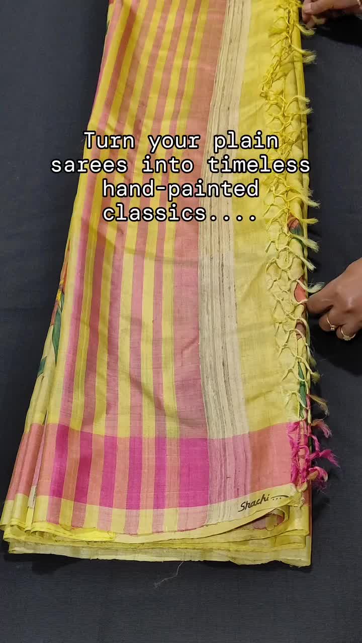 This may contain: a woman is sewing a yellow and pink saree with words written on the side