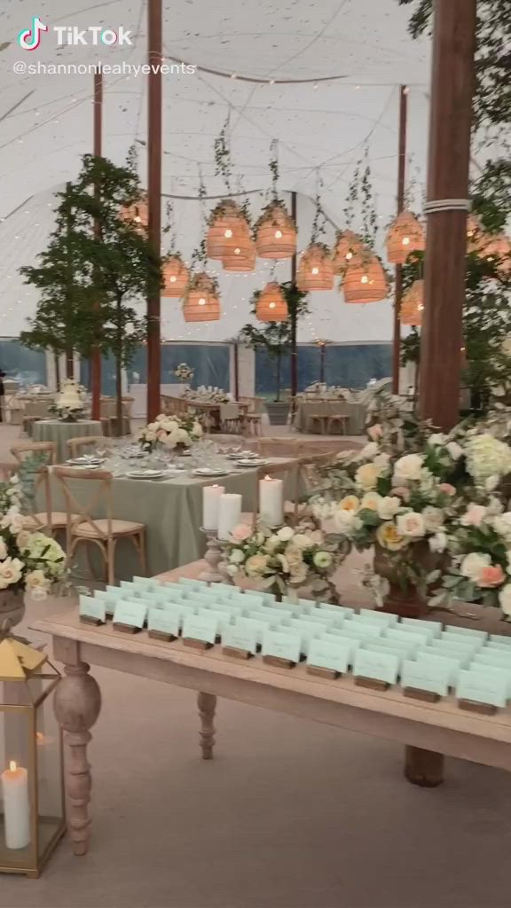 This may contain: an outdoor wedding setup with candles and flowers