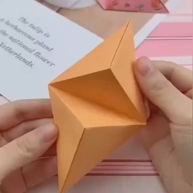 This may contain: someone is making an origami star out of paper